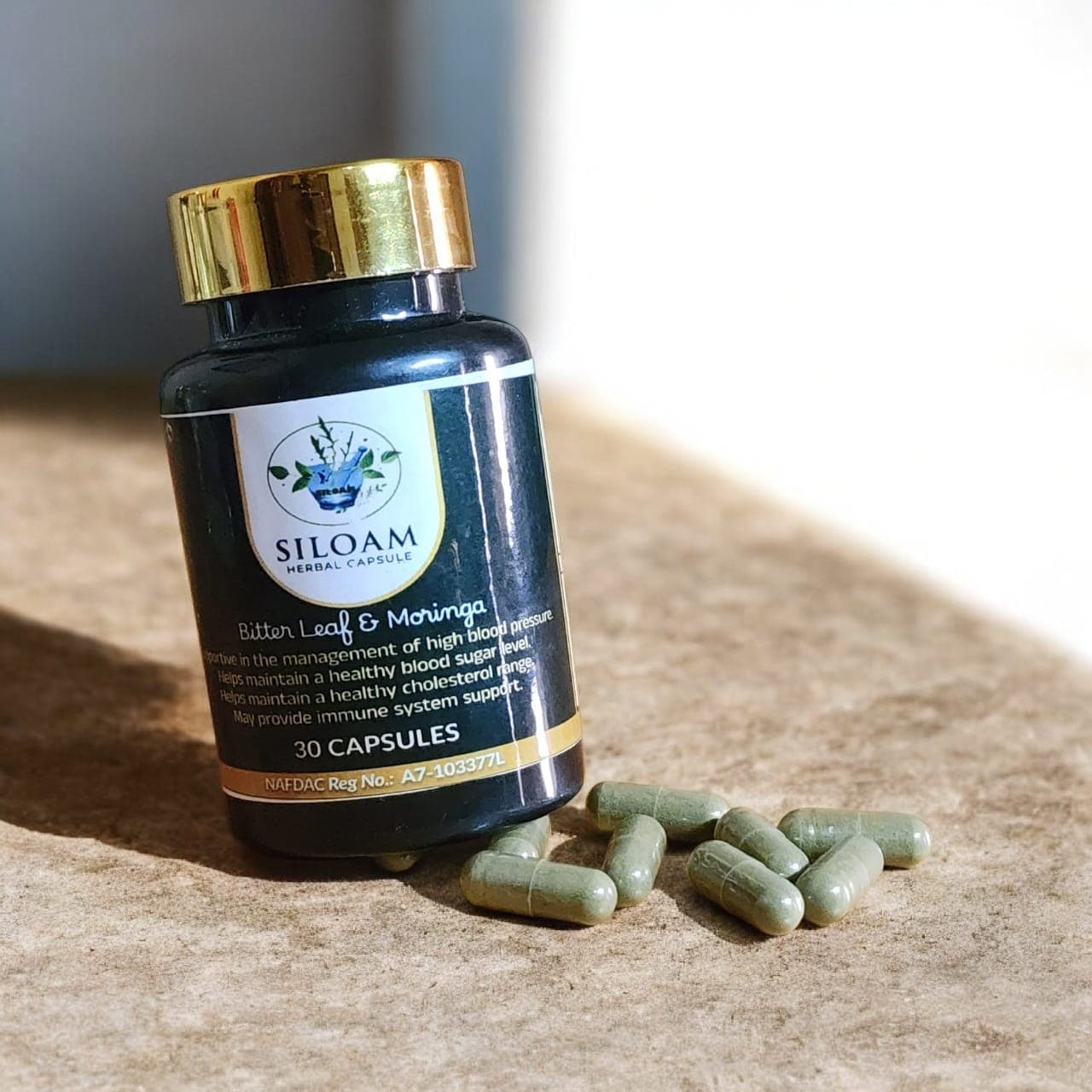 Siloam Herbal Capsule bottle with capsules beside it